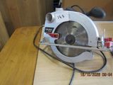 someone is using a circular saw to cut a piece of wood