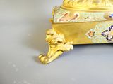 a gold and blue box on a white table