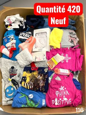 a cardboard box filled with clothes and other items