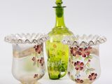 two glass vases and a bottle on a table