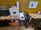 a desk with a computer, printer, and other items on it