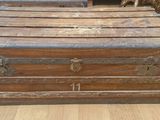 many old trunks sitting on the floor in a room