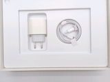 a white box with a charger and a cable attached to it