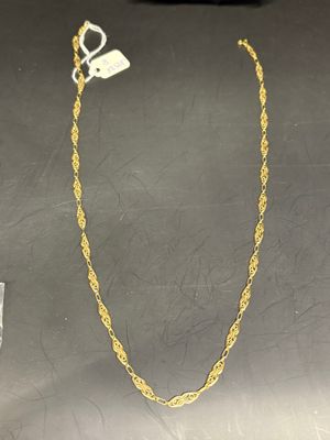 a close up of a gold chain with a tag on it