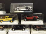 a lot of different model cars on display in a case