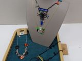 necklaces, bracelets, and necklaces are displayed on a display case