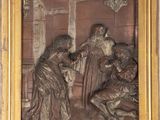 an image of a bronze relief of a group of people in a room