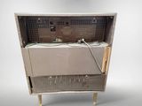 an old machine that is sitting on a stand