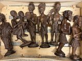 many wooden figurines in a box on a table