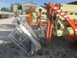 a crane that is sitting on the ground next to a pile of other equipment