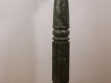an image of a green candle holder on a wooden table