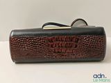 an image of a brown and black purse sitting on top of a table