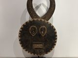 an image of a wooden mask with horns on a stand