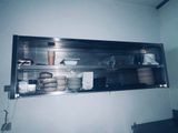 a shelf with dishes and cups on it in a kitchen