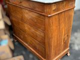 a wooden chest with a marble top in a room