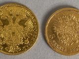 a close up of two gold coins on a white surface
