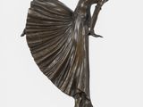 bronze statue of a woman with a fan on a marble base