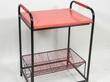 an image of a red metal shelf with a basket underneath it