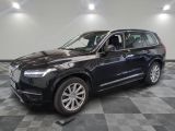 un SUV Volvo noir garé sur un sol à damier dans un showroom