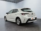 the rear end of a white toyota corollant parked in a garage