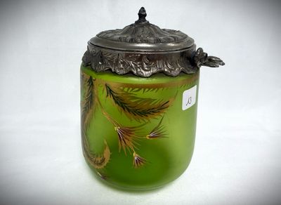 a glass jar with a lid that has a bird on it