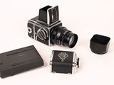 a small camera and a small camera case on a white surface