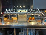 a metal bar with a bunch of beer taps on it
