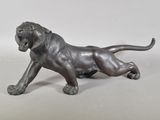 bronze statue of a lion on a white background