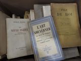 several books are stacked on top of each other in a box