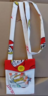 a red and white bag with a yellow button on it