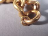 a close up of a gold chain on a table