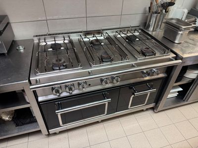 a kitchen with a stove, oven, and a microwave in it