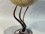 a glass bowl that is sitting on a stand