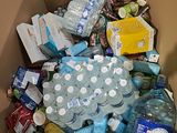 a cardboard box full of bottled water bottles and other items