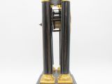 a black and gold clock that is on a stand