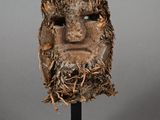 an image of a sculpture of a man ' s face on a black stand