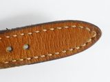 a brown leather watch strap with white stitching on it