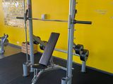 a gym with a bench, weights, and other equipment in the room