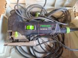 a corded sander with a green light on top of it