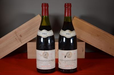 two bottles of wine sitting next to each other on a table