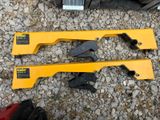 two tools that are laying on the ground next to each other