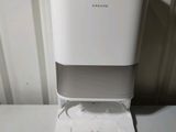 a white water dispenser sitting on a counter