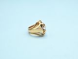 a close up of a gold ring on a blue surface