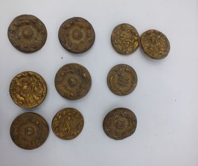 six pièces d'or posées les unes à côté des autres sur une surface blanche