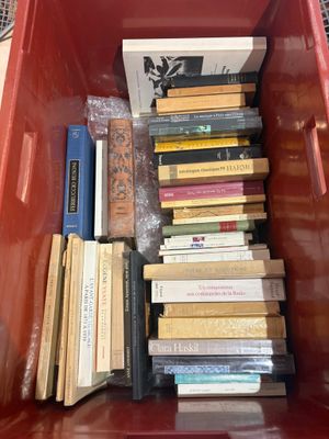 a red bin full of books sitting on the floor