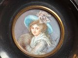 a picture of a woman with a blue hat on a plate