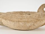 a small bird shaped object on a white surface