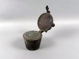 an old metal container with a lid and a metal handle