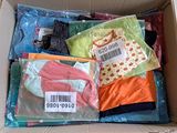 a cardboard box filled with lots of clothing and a price tag