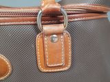 a close up of a purse with a tag on it